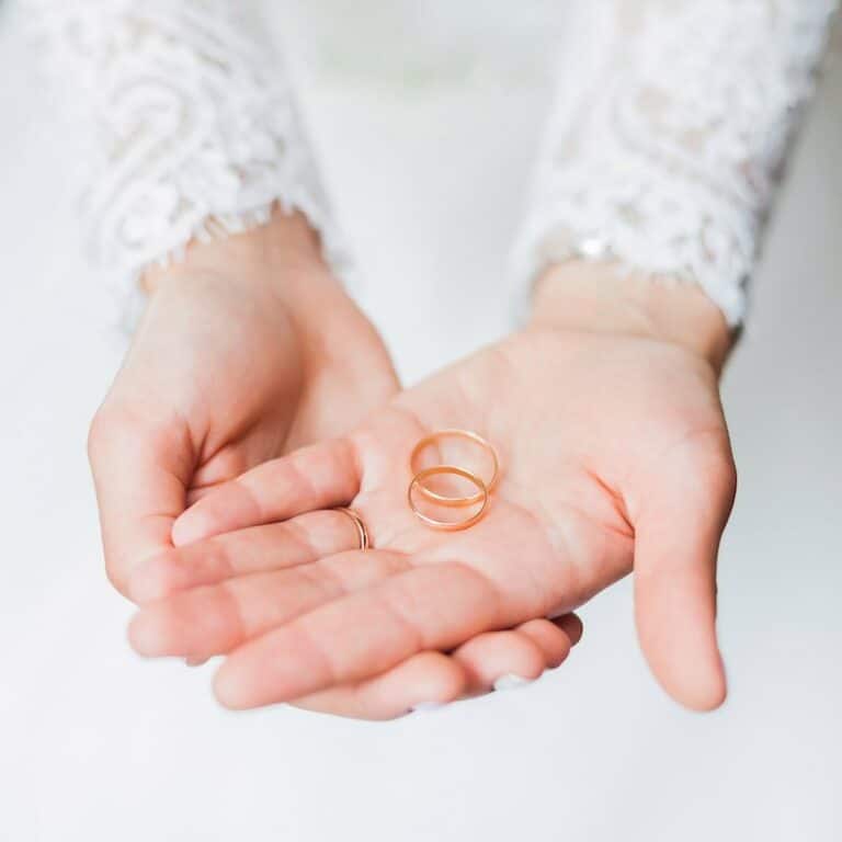 Bride with wedding bands in her hand